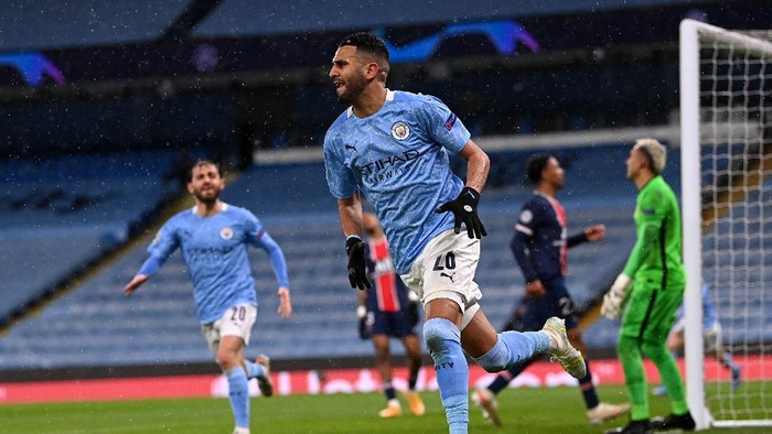 MANCHESTER, ENGLAND - MAY 04: Riyad Mahrez of Manchester City celebrates after scoring his teams second goal during the UEFA Champions League Semi Final Second Leg match between Manchester City and Paris Saint-Germain at Etihad Stadium on May 04, 2021 in Manchester, England. Sporting stadiums around the UK remain under strict restrictions due to the Coronavirus Pandemic as Government social distancing laws prohibit fans inside venues resulting in games being played behind closed doors. (Photo by Laurence Griffiths/Getty Images)