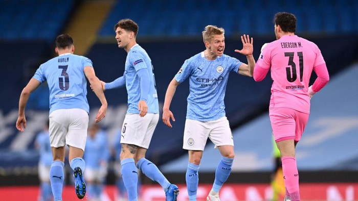 MANCHESTER, ENGLAND - MAY 04: Oleksandr Zinchenko of Manchester City celebrates his sides first goal which came from a Riyad Mahrez (not pictured) goal with Ederson of Manchester City during the UEFA Champions League Semi Final Second Leg match between Manchester City and Paris Saint-Germain at Etihad Stadium on May 04, 2021 in Manchester, England. Sporting stadiums around the UK remain under strict restrictions due to the Coronavirus Pandemic as Government social distancing laws prohibit fans inside venues resulting in games being played behind closed doors. (Photo by Laurence Griffiths/Getty Images)