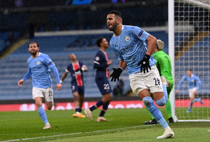 MANCHESTER, ENGLAND - MAY 04: Riyad Mahrez of Manchester City celebrates after scoring his teams second goal during the UEFA Champions League Semi Final Second Leg match between Manchester City and Paris Saint-Germain at Etihad Stadium on May 04, 2021 in Manchester, England. Sporting stadiums around the UK remain under strict restrictions due to the Coronavirus Pandemic as Government social distancing laws prohibit fans inside venues resulting in games being played behind closed doors. (Photo by Laurence Griffiths/Getty Images)