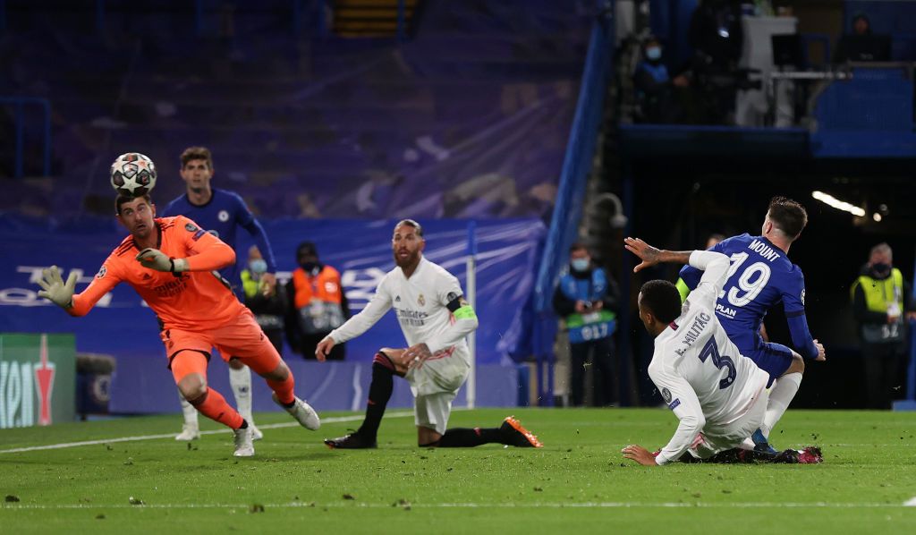 LONDON, ENGLAND - MAY 05: Mason Mount of Chelsea scores his team's second goal past Thibaut Courtois of Real Madrid during the UEFA Champions League Semi Final Second Leg match between Chelsea and Real Madrid at Stamford Bridge on May 05, 2021 in London, England. Sporting stadiums around Europe remain under strict restrictions due to the Coronavirus Pandemic as Government social distancing laws prohibit fans inside venues resulting in games being played behind closed doors. (Photo by Clive Rose/Getty Images)