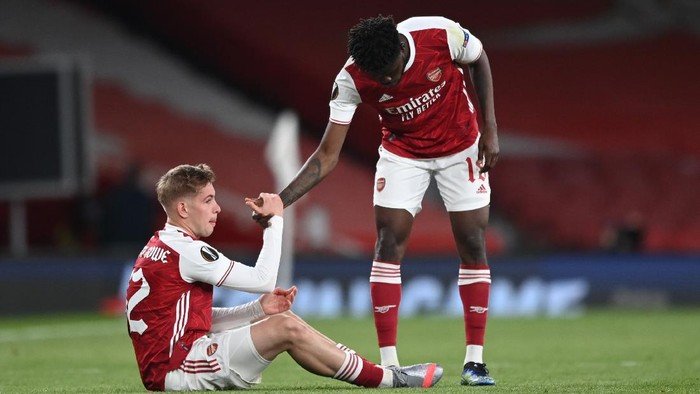 LONDON, ENGLAND - MAY 06: Emile Smith Rowe (L) of Arsenal is helped up by team mate Thomas Partey as they both look dejected following the UEFA Europa League Semi-final Second Leg match between Arsenal and Villareal CF at Emirates Stadium on May 06, 2021 in London, England. Sporting stadiums around Europe remain under strict restrictions due to the Coronavirus Pandemic as Government social distancing laws prohibit fans inside venues resulting in games being played behind closed doors. (Photo by Shaun Botterill/Getty Images)