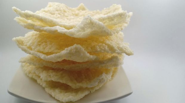 Traditional Indonesian food, gendar crackers. crackers made from spiced rice dough and flavor enhancer. Very crispy and savory taste. Served on white plate. Isolated on white background.