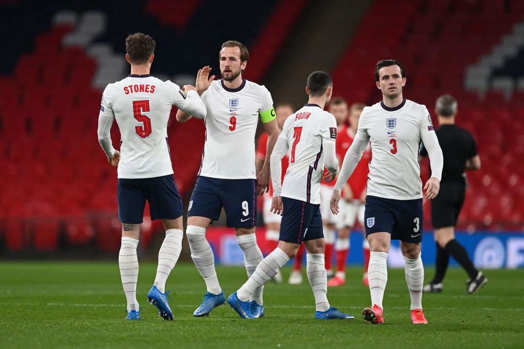 LONDON, ENGLAND - MARCH 31: Harry Kane of England interacts with John Stones of England prior to the FIFA World Cup 2022 Qatar qualifying match between England and Poland on March 31, 2021 at Wembley Stadium in London, England. Sporting stadiums around the UK remain under strict restrictions due to the Coronavirus Pandemic as Government social distancing laws prohibit fans inside venues resulting in games being played behind closed doors. (Photo by Andy Rain - Pool/Getty Images)