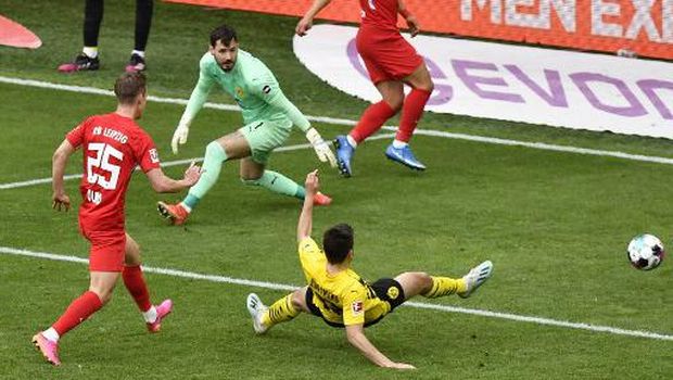 Leipzig's Spanish midfielder Dani Olmo (L) scores during the German first division Bundesliga football match BVB Borussia Dortmund v RB Leipzig in Dortmund, western Germany on May 8, 2021. (Photo by Martin Meissner / POOL / AFP) / DFL REGULATIONS PROHIBIT ANY USE OF PHOTOGRAPHS AS IMAGE SEQUENCES AND/OR QUASI-VIDEO