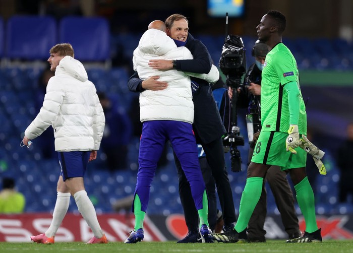 LONDON, ENGLAND - MAY 05: Willy Caballero and Edouard Mendy of Chelsea celebrate with Thomas Tuchel, Manager of Chelsea following victory during the UEFA Champions League Semi Final Second Leg match between Chelsea and Real Madrid at Stamford Bridge on May 05, 2021 in London, England. Sporting stadiums around Europe remain under strict restrictions due to the Coronavirus Pandemic as Government social distancing laws prohibit fans inside venues resulting in games being played behind closed doors. (Photo by Clive Rose/Getty Images)