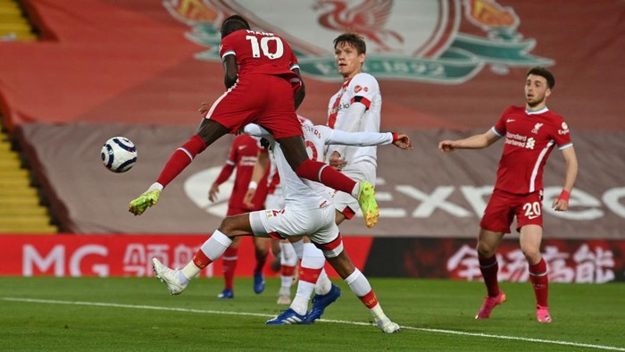 LIVERPOOL, ENGLAND - MAY 08: Sadio Mane of Liverpool scores their sides first goal during the Premier League match between Liverpool and Southampton at Anfield on May 08, 2021 in Liverpool, England. Sporting stadiums around the UK remain under strict restrictions due to the Coronavirus Pandemic as Government social distancing laws prohibit fans inside venues resulting in games being played behind closed doors. (Photo by Paul Ellis - Pool/Getty Images)