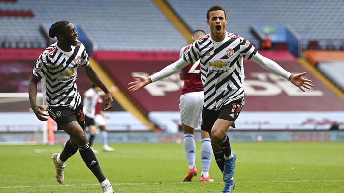 Manchester Uniteds Mason Greenwood, right, celebrates after scoring his sides second goal during the English Premier League soccer match between Aston Villa and Manchester United at Villa Park in Birmingham, England, Sunday, May 9, 2021. (Shaun Botterill/Pool via AP)