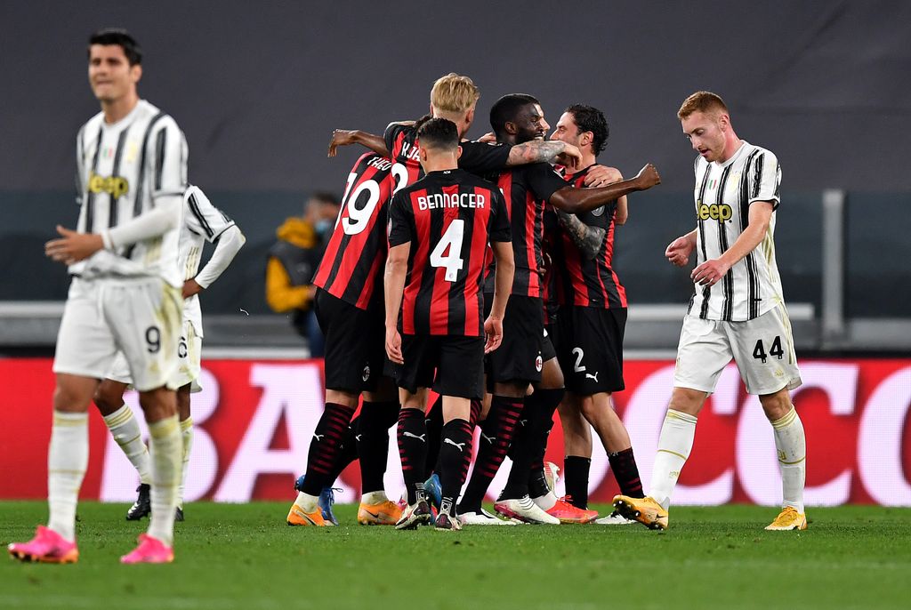TURIN, ITALY - MAY 09: Ante Rebic of A.C. Milan (hidden) celebrates with team mates after scoring their side's second goal during the Serie A match between Juventus  and AC Milan at  on May 09, 2021 in Turin, Italy. Sporting stadiums around Italy remain under strict restrictions due to the Coronavirus Pandemic as Government social distancing laws prohibit fans inside venues resulting in games being played behind closed doors. (Photo by Valerio Pennicino/Getty Images)