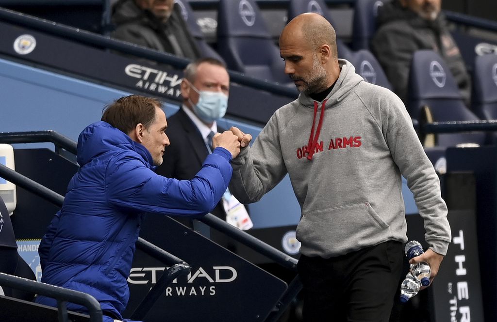 Chelsea's head coach Thomas Tuchel, left, and Manchester City's head coach Pep Guardiola chat before the start of the English Premier League soccer match between Manchester City and Chelsea at the Etihad Stadium in Manchester, Saturday, May 8, 2021.(Shaun Botterill/Pool via AP)
