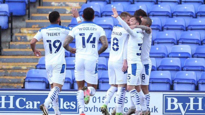 BIRKENHEAD, ENGLAND - APRIL 05: Paul Lewis of Tranmere Rovers celebrates with Liam Feeney, Calum MacDonald and Danny Lloyd after scoring their sides first goal during the Sky Bet League Two match between Tranmere Rovers and Cambridge United at Prenton Park on April 05, 2021 in Birkenhead, England. Sporting stadiums around the UK remain under strict restrictions due to the Coronavirus Pandemic as Government social distancing laws prohibit fans inside venues resulting in games being played behind closed doors. (Photo by Lewis Storey/Getty Images)