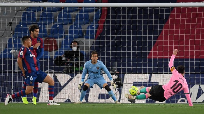 VALENCIA, SPAIN - MAY 11: Lionel Messi of Barcelona scores the opening goal during the La Liga Santander match between Levante UD and FC Barcelona at Ciutat de Valencia Stadium on May 11, 2021 in Valencia, Spain. Sporting stadiums around Spain remain under strict restrictions due to the Coronavirus Pandemic as Government social distancing laws prohibit fans inside venues resulting in games being played behind closed doors. (Photo by Alex Caparros/Getty Images)