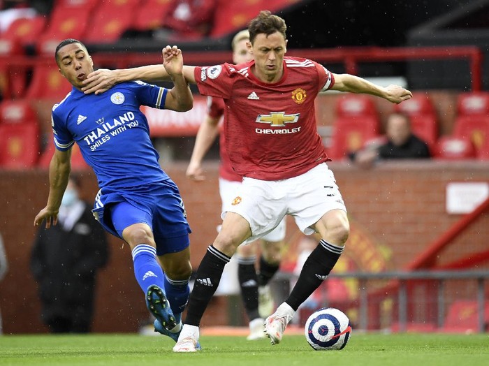 Manchester Uniteds Nemanja Matic, right, duels for the ball with Leicesters Youri Tielemans during the English Premier League soccer match between Manchester United and Leicester City, at the Old Trafford stadium in Manchester, England, Tuesday, May 11, 2021. (Peter Powell/Pool via AP)