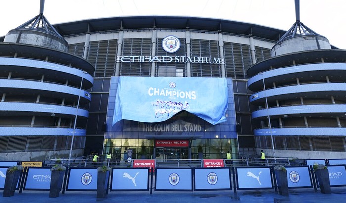 A banner is unfurled outside the Etihad Stadium in Manchester, England, Tuesday, May 11, 2021 after the Manchester City team clinched the English Premier League title. City took the title after crosstown rivals Manchester United lost at home to Leicester City. (AP Photo/Jon Super)