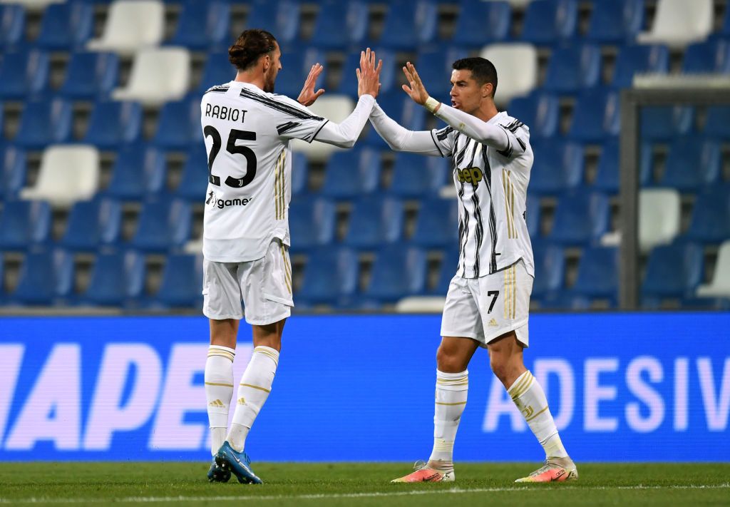 REGGIO NELL'EMILIA, ITALY - MAY 12: Adrien Rabiot of Juventus celebrates with Cristiano Ronaldo after scoring their side's first goal during the Serie A match between US Sassuolo and Juventus at Mapei Stadium - Città del Tricolore on May 12, 2021 in Reggio nell'Emilia, Italy. Sporting stadiums around Italy remain under strict restrictions due to the Coronavirus Pandemic as Government social distancing laws prohibit fans inside venues resulting in games being played behind closed doors.  (Photo by Alessandro Sabattini/Getty Images)