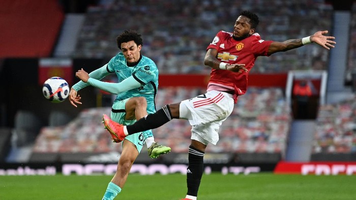 MANCHESTER, ENGLAND - MAY 13: Trent Alexander-Arnold of Liverpool is challenged by Fred of Manchester United during the Premier League match between Manchester United and Liverpool at Old Trafford on May 13, 2021 in Manchester, England. Sporting stadiums around the UK remain under strict restrictions due to the Coronavirus Pandemic as Government social distancing laws prohibit fans inside venues resulting in games being played behind closed doors. (Photo by Michael Regan/Getty Images)