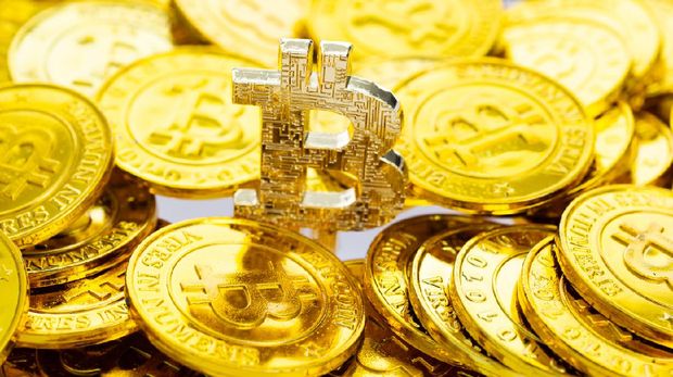 Fujian, China - November 15, 2018: Bunch of memorial golden bitcoins. Bitcoin is a worldwide digital currency that isn't controlled by a central authority such as a government or bank.