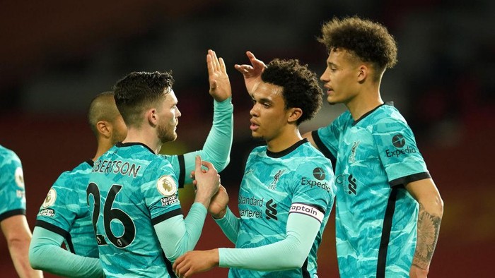 MANCHESTER, ENGLAND - MAY 13: Andrew Robertson and Trent Alexander-Arnold of Liverpool celebrate victory after the Premier League match between Manchester United and Liverpool at Old Trafford on May 13, 2021 in Manchester, England. Sporting stadiums around the UK remain under strict restrictions due to the Coronavirus Pandemic as Government social distancing laws prohibit fans inside venues resulting in games being played behind closed doors. (Photo by Dave Thompson - Pool/Getty Images)