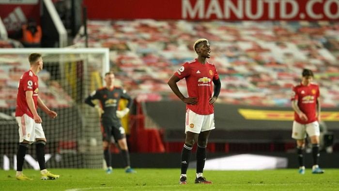 MANCHESTER, ENGLAND - MAY 13: Paul Pogba of Manchester United looks dejected after conceding a fourth goal scored by Mohamed Salah of Liverpool (not pictured) during the Premier League match between Manchester United and Liverpool at Old Trafford on May 13, 2021 in Manchester, England. Sporting stadiums around the UK remain under strict restrictions due to the Coronavirus Pandemic as Government social distancing laws prohibit fans inside venues resulting in games being played behind closed doors. (Photo by Dave Thompson - Pool/Getty Images)