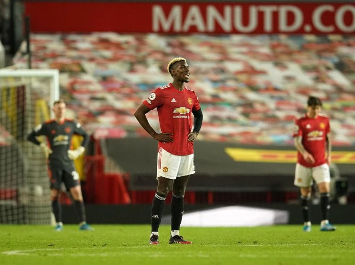 MANCHESTER, ENGLAND - MAY 13: Paul Pogba of Manchester United looks dejected after conceding a fourth goal scored by Mohamed Salah of Liverpool (not pictured) during the Premier League match between Manchester United and Liverpool at Old Trafford on May 13, 2021 in Manchester, England. Sporting stadiums around the UK remain under strict restrictions due to the Coronavirus Pandemic as Government social distancing laws prohibit fans inside venues resulting in games being played behind closed doors. (Photo by Dave Thompson - Pool/Getty Images)