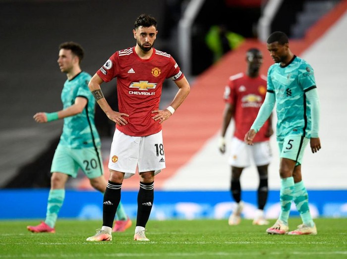 MANCHESTER, ENGLAND - MAY 13: Bruno Fernandes of Manchester United looks dejected after conceding a second goal scored by Roberto Firmino of Liverpool (not pictured) during the Premier League match between Manchester United and Liverpool at Old Trafford on May 13, 2021 in Manchester, England. Sporting stadiums around the UK remain under strict restrictions due to the Coronavirus Pandemic as Government social distancing laws prohibit fans inside venues resulting in games being played behind closed doors. (Photo by Peter Powell - Pool/Getty Images)