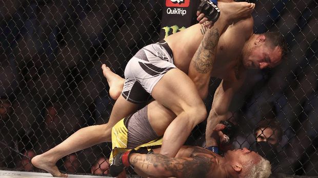 May 15, 2021; Houston, Texas, USA; Michael Chandler moves in for a hit against Charles Oliveira during UFC 262 at Toyota Center. Mandatory Credit: Troy Taormina-USA TODAY Sports