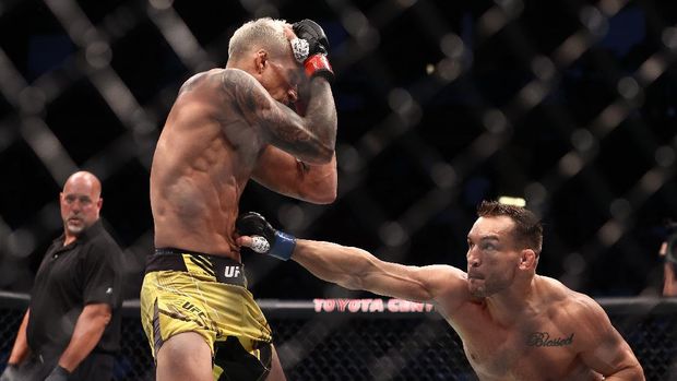 May 15, 2021; Houston, Texas, USA; Michael Chandler moves in for a hit against Charles Oliveira during UFC 262 at Toyota Center. Mandatory Credit: Troy Taormina-USA TODAY Sports