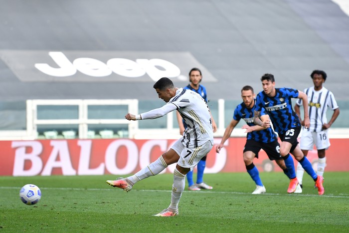 Cristiano Ronaldo TURIN, ITALY - MAY 15: Cristiano Ronaldo of Juventus takes a penalty which is parried out, the rebound is later scored for Juventus' first goal scored by Cristiano Ronaldo during the Serie A match between Juventus and FC Internazionale at on May 15, 2021 in Turin, Italy. Sporting stadiums around Italy remain under strict restrictions due to the Coronavirus Pandemic as Government social distancing laws prohibit fans inside venues resulting in games being played behind closed doors. (Photo by Valerio Pennicino/Getty Images)