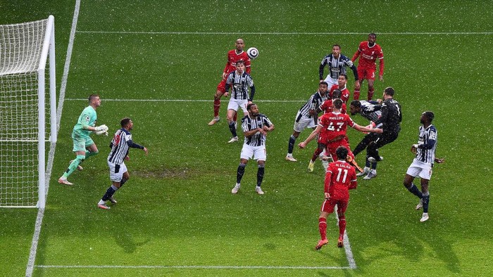 WEST BROMWICH, ENGLAND - MAY 16: Alisson of Liverpool scores their sides second goal past Sam Johnstone of West Bromwich Albion during the Premier League match between West Bromwich Albion and Liverpool at The Hawthorns on May 16, 2021 in West Bromwich, England. Sporting stadiums around the UK remain under strict restrictions due to the Coronavirus Pandemic as Government social distancing laws prohibit fans inside venues resulting in games being played behind closed doors. (Photo by Laurence Griffiths/Getty Images)