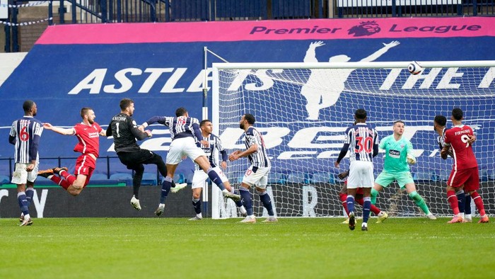 Alisson Becker WEST BROMWICH, ENGLAND - MAY 16: Alisson of Liverpool scores their side's second goal past Sam Johnstone of West Bromwich Albion during the Premier League match between West Bromwich Albion and Liverpool at The Hawthorns on May 16, 2021 in West Bromwich, England. Sporting stadiums around the UK remain under strict restrictions due to the Coronavirus Pandemic as Government social distancing laws prohibit fans inside venues resulting in games being played behind closed doors. (Photo by Tim Keeton - Pool/Getty Images)