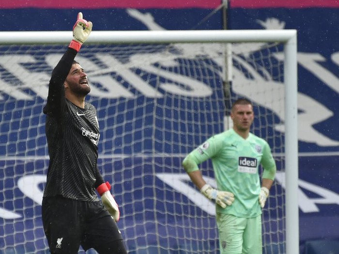 Liverpool's goalkeeper Alisson celebrates after scoring his side's second goal during the English Premier League soccer match between West Bromwich Albion and Liverpool at the Hawthorns stadium in West Bromwich, England, Sunday, May 16, 2021. (AP Photo/Rui Vieira, Pool)