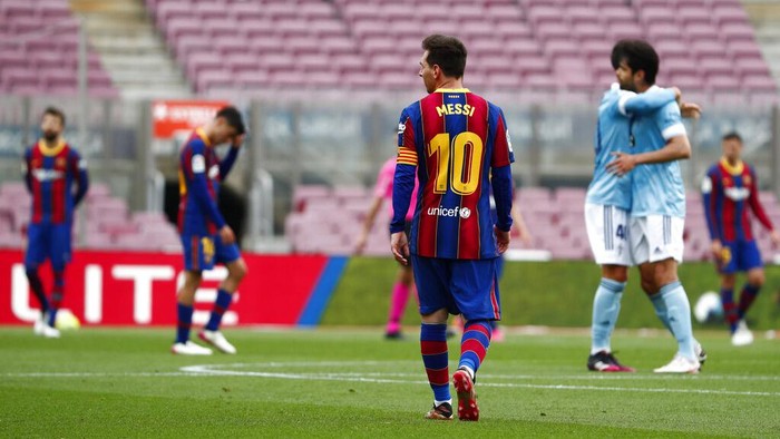 Barcelonas Lionel Messi walks as Celta players celebrate scoring their sides first goal during the Spanish La Liga soccer match between FC Barcelona and Celta at the Camp Nou stadium in Barcelona, Spain, Sunday, May. 16, 2021. (AP Photo/Joan Monfort)