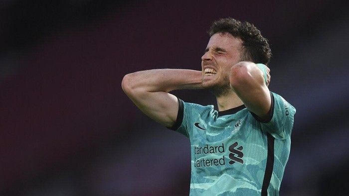 Liverpools Diogo Jota celebrates after scoring his sides opening goal during the English Premier League soccer match between Manchester United and Liverpool, at the Old Trafford stadium in Manchester, England, Thursday, May 13, 2021. (Michael Regan/Pool via AP)
