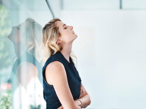 Shot of a young businesswoman looking stressed out in an office