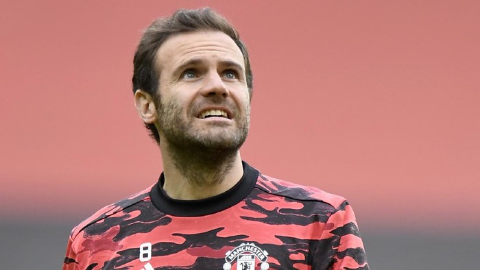 Manchester United's Juan Mata heads the ball during warm up before the English Premier League soccer match between Manchester United and Leicester City, at the Old Trafford stadium in Manchester, England, Tuesday, May 11, 2021. (Peter Powell/Pool via AP)