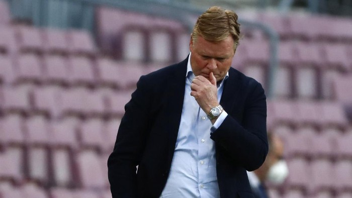 Barcelonas head coach Ronald Koeman reacts as he watches the game during the Spanish La Liga soccer match between FC Barcelona and Celta at the Camp Nou stadium in Barcelona, Spain, Sunday, May. 16, 2021. (AP Photo/Joan Monfort)