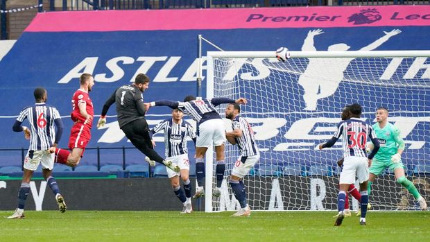 WEST BROMWICH, ENGLAND - MAY 16: Alisson of Liverpool scores their side's second goal past Sam Johnstone of West Bromwich Albion during the Premier League match between West Bromwich Albion and Liverpool at The Hawthorns on May 16, 2021 in West Bromwich, England. Sporting stadiums around the UK remain under strict restrictions due to the Coronavirus Pandemic as Government social distancing laws prohibit fans inside venues resulting in games being played behind closed doors. (Photo by Tim Keeton - Pool/Getty Images)