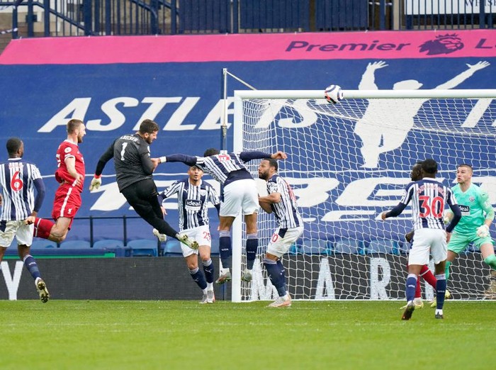 WEST BROMWICH, ENGLAND - MAY 16: Alisson of Liverpool scores their side's second goal past Sam Johnstone of West Bromwich Albion during the Premier League match between West Bromwich Albion and Liverpool at The Hawthorns on May 16, 2021 in West Bromwich, England. Sporting stadiums around the UK remain under strict restrictions due to the Coronavirus Pandemic as Government social distancing laws prohibit fans inside venues resulting in games being played behind closed doors. (Photo by Tim Keeton - Pool/Getty Images)