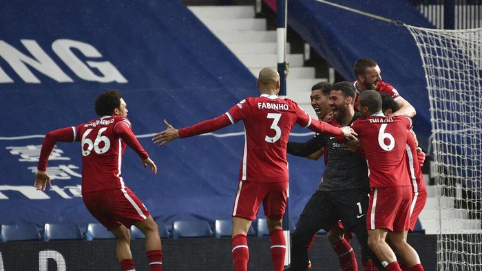 Liverpools goalkeeper Alisson celebrates with teammates after scoring his sides second goal during the English Premier League soccer match between West Bromwich Albion and Liverpool at the Hawthorns stadium in West Bromwich, England, Sunday, May 16, 2021. (AP Photo/Rui Vieira, Pool)