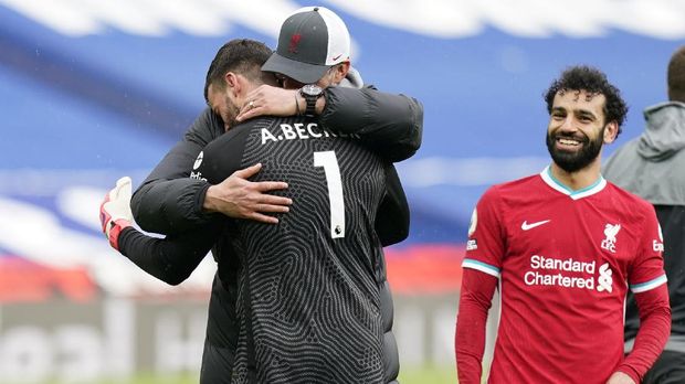 Soccer Football - Premier League - West Bromwich Albion v Liverpool - The Hawthorns, West Bromwich, Britain - May 16, 2021 Liverpool's Alisson celebrates with manager Juergen Klopp after the match as Mohamed Salah looks on Pool via REUTERS/Tim Keeton EDITORIAL USE ONLY. No use with unauthorized audio, video, data, fixture lists, club/league logos or 'live' services. Online in-match use limited to 75 images, no video emulation. No use in betting, games or single club /league/player publications.  Please contact your account representative for further details.