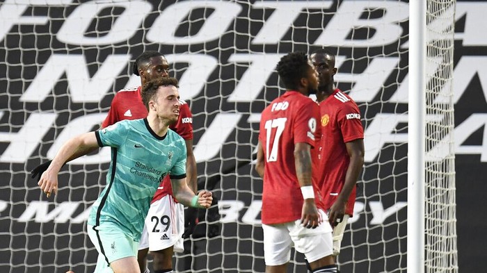 Liverpools Diogo Jota, left, celebrates after scoring his sides opening goal during the English Premier League soccer match between Manchester United and Liverpool, at the Old Trafford stadium in Manchester, England, Thursday, May 13, 2021. (Peter Powell/Pool via AP)
