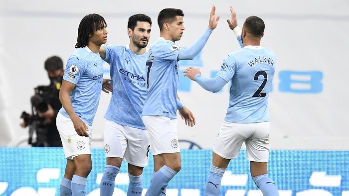 NEWCASTLE UPON TYNE, ENGLAND - MAY 14: Joao Cancelo of Manchester City celebrates with Kyle Walker after scoring their sides first goal during the Premier League match between Newcastle United and Manchester City at St. James Park on May 14, 2021 in Newcastle upon Tyne, England. Sporting stadiums around the UK remain under strict restrictions due to the Coronavirus Pandemic as Government social distancing laws prohibit fans inside venues resulting in games being played behind closed doors.  (Photo by Peter Powell - Pool/Getty Images)