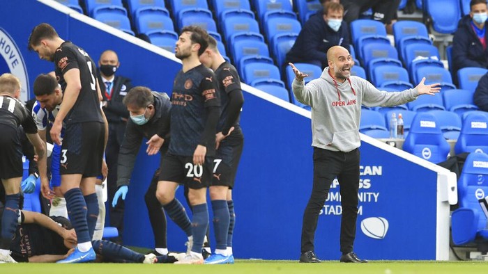 Manchester Citys head coach Pep Guardiola gestures during the English Premier League soccer match between Brighton & Hove Albion and Manchester City at the Amex stadium in Brighton, England, Tuesday, May 18, 2021. (Gareth Fuller, Pool via AP)