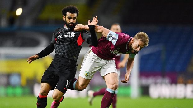 SOCCER-ENGLAND-BUR-LIV/REPORT Soccer Football - Premier League - Burnley v Liverpool - Turf Moor, Burnley, Britain - May 19, 2021 Liverpool's Mohamed Salah in action with Burnley's Charlie Taylor Pool via REUTERS/Clive Mason EDITORIAL USE ONLY. No use with unauthorized audio, video, data, fixture lists, club/league logos or 'live' services. Online in-match use limited to 75 images, no video emulation. No use in betting, games or single club /league/player publications. Please contact your account representative for further details.