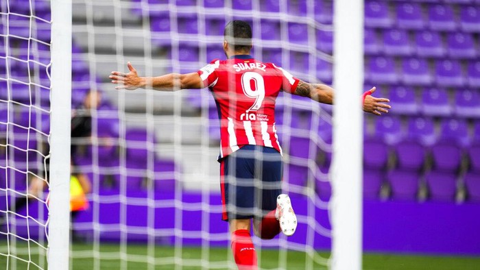 Atletico Madrids Luis Suarez celebrates after scoring his sides second goal during the Spanish La Liga soccer match between Atletico Madrid and Valladolid at the Jose Zorrilla stadium in Valladolid, Spain, Saturday, May 22, 2021. (AP Photo/Manu Fernandez)