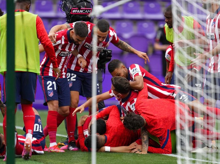 Atletico Madrid players celebrate after teammate Luis Suarez scored a goal during the Spanish La Liga soccer match between Atletico Madrid and Valladolid at the Jose Zorrilla stadium in Valladolid, Spain, Saturday, May 22, 2021. Atletico won 2-1 and clinches its 11th Spanish La Liga title. (AP Photo/Manu Fernandez)