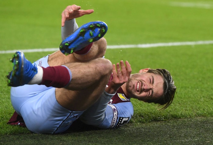 Jack Grealish BRIGHTON, ENGLAND - FEBRUARY 13: Jack Grealish of Aston Villa reacts after being challenged by Steven Alzate (Not pictured) of Brighton & Hove Albion during the Premier League match between Brighton & Hove Albion and Aston Villa at American Express Community Stadium on February 13, 2021 in Brighton, England. Sporting stadiums around the UK remain under strict restrictions due to the Coronavirus Pandemic as Government social distancing laws prohibit fans inside venues resulting in games being played behind closed doors. (Photo by Neil Hall - Pool/Getty Images)