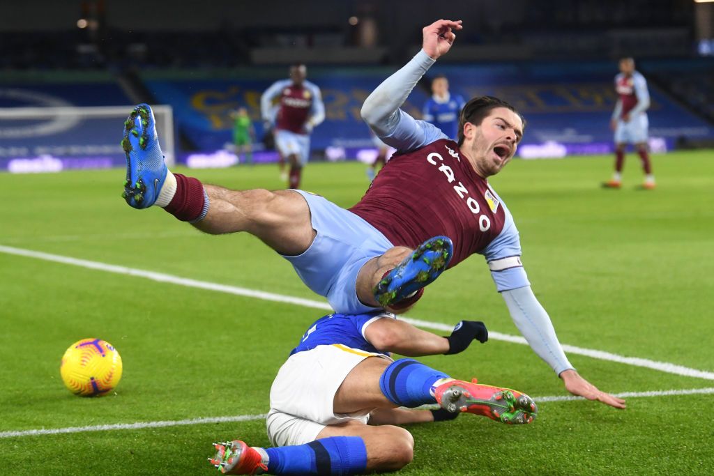 BRIGHTON, ENGLAND - FEBRUARY 13: Jack Grealish of Aston Villa reacts after being challenged by Steven Alzate (Not pictured) of Brighton & Hove Albion during the Premier League match between Brighton & Hove Albion and Aston Villa at American Express Community Stadium on February 13, 2021 in Brighton, England. Sporting stadiums around the UK remain under strict restrictions due to the Coronavirus Pandemic as Government social distancing laws prohibit fans inside venues resulting in games being played behind closed doors. (Photo by Neil Hall - Pool/Getty Images)