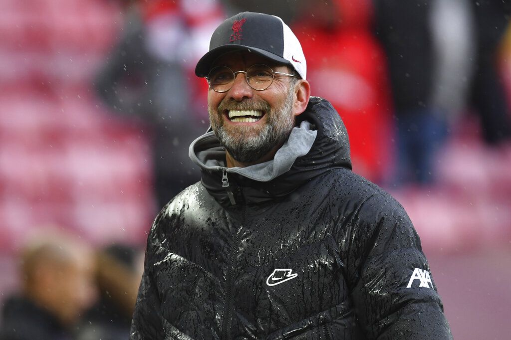 Liverpool's manager Jurgen Klopp smiles as he does a walk around the pitch after the English Premier League soccer match between Liverpool and Crystal Palace at Anfield stadium in Liverpool, England, Sunday, May 23, 2021. (Paul Ellis/Pool via AP)