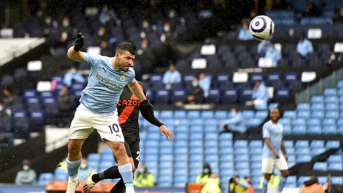 Manchester Citys Sergio Aguero heads the ball to score his sides fifth goal during the English Premier League soccer match between Manchester City and Everton at the Etihad stadium in Manchester, Sunday, May 23, 2021.(Peter Powel/Pool via AP)