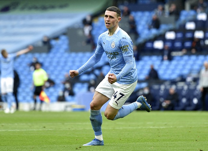 Manchester City's Phil Foden celebrates scoring his side's third goal during the English Premier League soccer match between Manchester City and Everton at the Etihad stadium in Manchester, Sunday, May 23, 2021.(Peter Powel/Pool via AP)